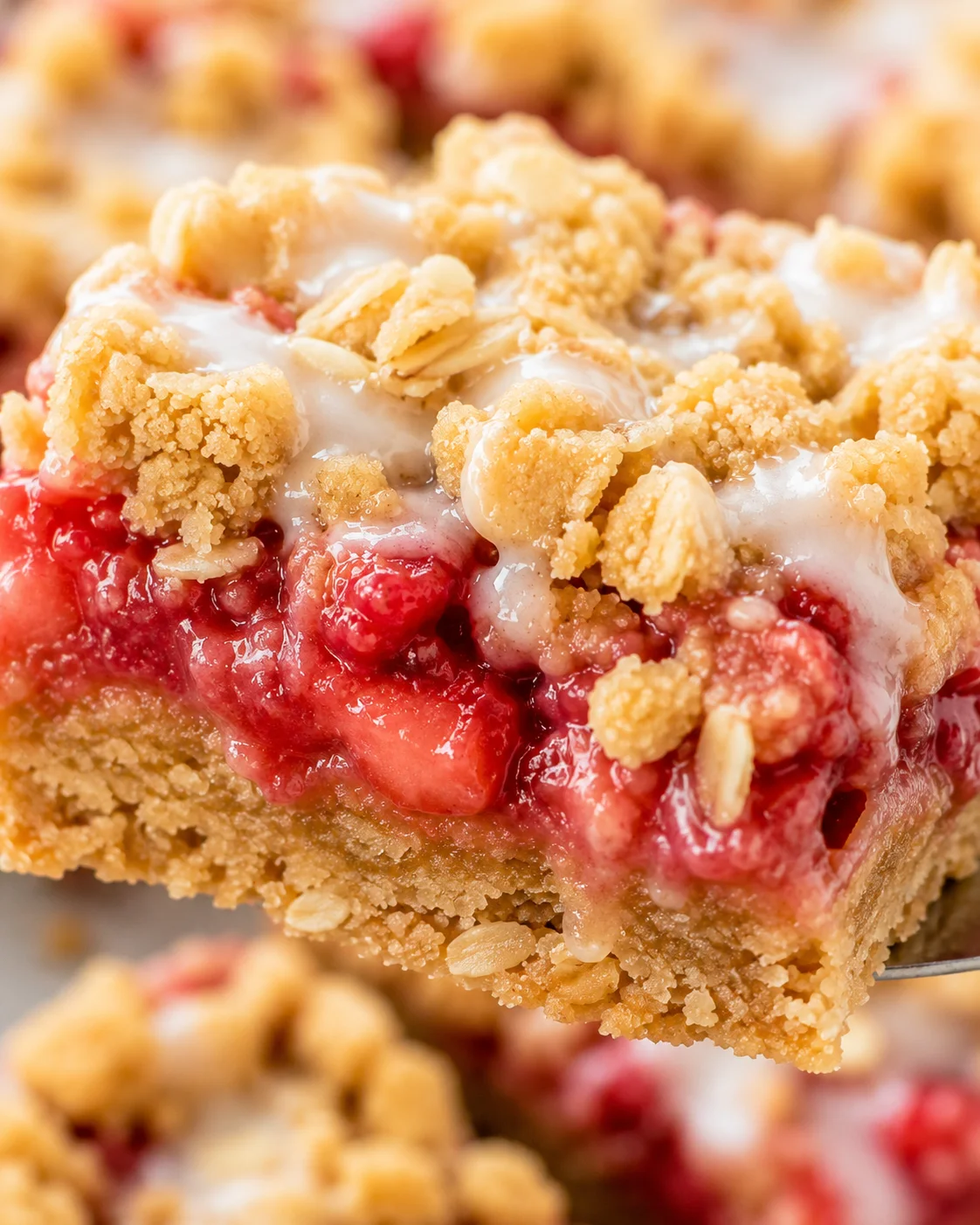 Close-up of baked strawberry oatmeal bar with oat crumble topping