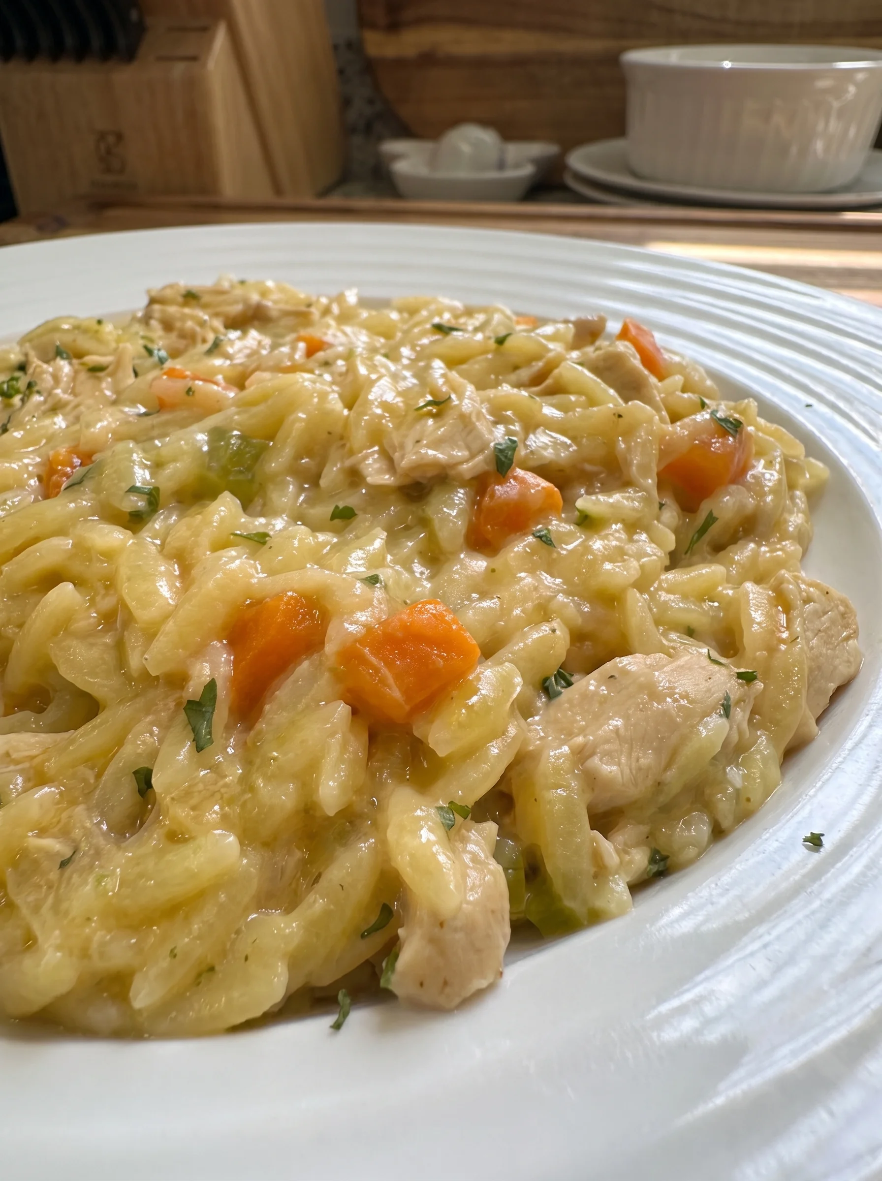 Close-up of creamy chicken pot pie orzo served on a white plate