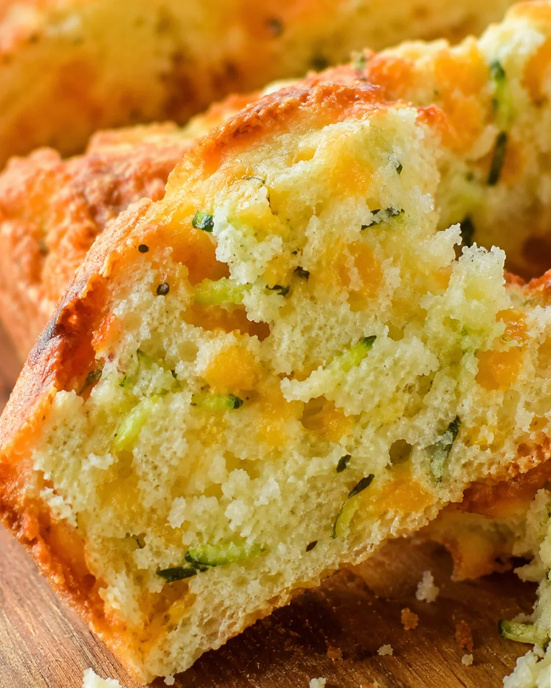 Cheddar Zucchini Herb Beer Bread Close-up of a freshly baked loaf of cheddar zucchini beer bread with herbs.